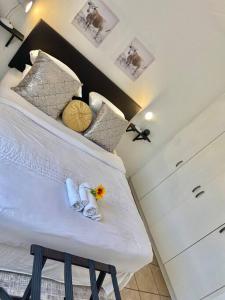 a bedroom with a bed with a flower on it at Mall of Africa View in Midrand