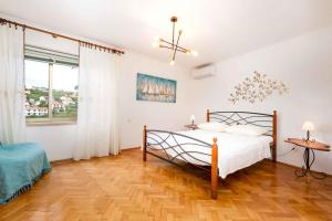 a bedroom with a bed and a wooden floor at Holiday home in Vrbnik/Insel Krk 36717 in Vrbnik