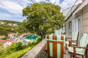 a balcony with chairs and a view of a harbor at Holiday home in Vrbnik/Insel Krk 36717 in Vrbnik