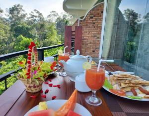 a table with plates of food and drinks on a balcony at Nine Arch Gap in Ella