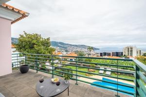 a balcony with a view of a city at Villa Magnólia in Funchal