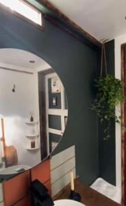 a bathroom with a mirror and a table and a sink at Spacious & Light Studio Loft in Alloa