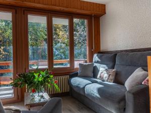 a living room with a couch and some windows at Apartment Derborence 25 by Interhome in Nendaz +28 photos