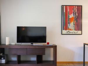 a tv sitting on a desk in a room at Apartment Allod-Park-15 by Interhome in Davos