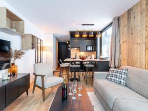 a living room and kitchen with a couch and a table at Apartment Le Bollin - Val Claret-4 by Interhome in Tignes