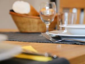 a table with a plate and a glass of wine at Apartment Allod Park Haus C 205 by Interhome in Davos