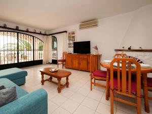 a living room with a couch and a table at Holiday Home Mara by Interhome in Casas de Torrat