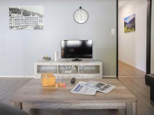 a living room with a coffee table and a tv at Apartment Allod-Park-22 by Interhome in Davos