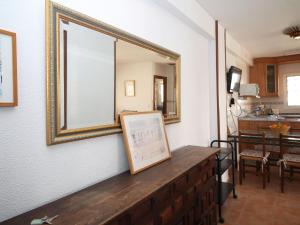 a mirror on a wall with a wooden dresser at Apartment El Junco by Interhome in Benidorm