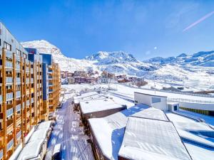 a city with snow covered mountains in the background at Apartment Arcelle-16 by Interhome in Val Thorens