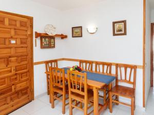 a dining room with a wooden table and chairs at Holiday Home Montalt I by Interhome in Miami Platja