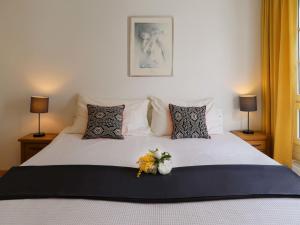 a bedroom with a bed with a bouquet of flowers on it at Apartment Mon Repos by Interhome in Davos