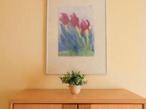 a plant in a vase on top of a wooden cabinet at Apartment Allod Park Haus C 603 by Interhome in Davos +40 photos