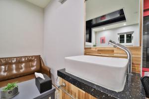 a kitchen with a white sink in a room at Evian Hotel in Gyeongsan