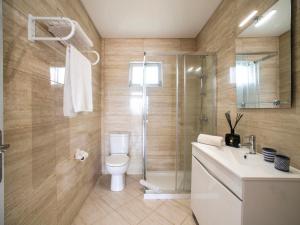 a bathroom with a shower and a toilet and a sink at Apartment Quinta Girassol-6 by Interhome in Loulé