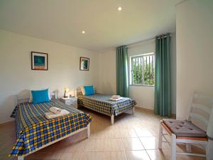 a hotel room with two beds and a window at Apartment Quinta Girassol-6 by Interhome in Loulé