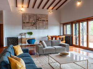 a living room with a blue couch and a table at Villa Villa Valentina by Interhome in Pisciarelli