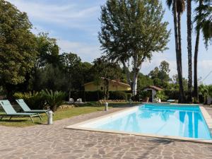 a swimming pool with a chair next to a house at Villa Villa Valentina by Interhome in Pisciarelli