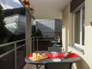 a table on a balcony with a view of a building at Apartment Allod-Park-39 by Interhome in Davos