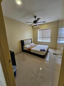 a bedroom with a bed and a ceiling fan at Newly refurbished Cozy PD Bayview Apartment with Ocean View in Port Dickson