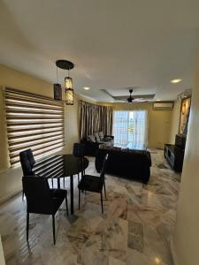 a living room with a table and a couch at Newly refurbished Cozy PD Bayview Apartment with Ocean View in Port Dickson