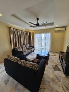 a living room with a couch and a table at Newly refurbished Cozy PD Bayview Apartment with Ocean View in Port Dickson