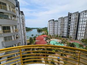 a view of a river from a balcony with buildings at Newly refurbished Cozy PD Bayview Apartment with Ocean View in Port Dickson