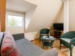 a living room with a couch and chairs and a tv at Apartment Melchien 2 by Interhome in Zinnowitz +8 photos