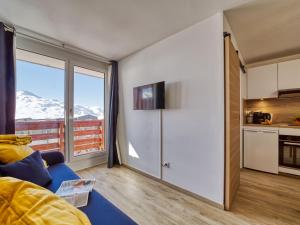 a living room with a view of a mountain at Apartment Altineige-6 by Interhome in Val Thorens