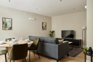 a living room with a couch and a table at Chancery Lane by Viridian Apartments in London