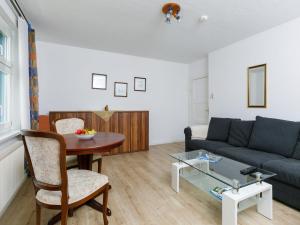 a living room with a couch and a table at Apartment Melchien 1 by Interhome in Zinnowitz +14 photos