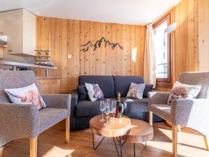 a living room with a couch and chairs and a table at Apartment Le Curling B - Val Claret-41 by Interhome in Tignes