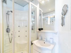 a white bathroom with a shower and a sink at Apartment Le Curling B - Val Claret-41 by Interhome in Tignes