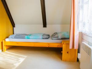 a bed with two pillows on it in a room at Holiday Home Kemp Stříbrný rybník-9 by Interhome in Hradec Králové