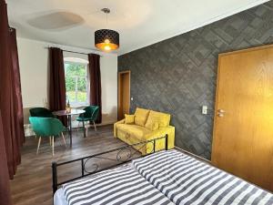 een slaapkamer met een bed, een stoel en een tafel bij Apartment Pumphut by Interhome 