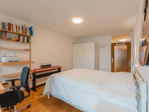 a bedroom with a bed and a desk and a desk at Apartment Unser Glück in den Bergen by Interhome in Bad Gastein