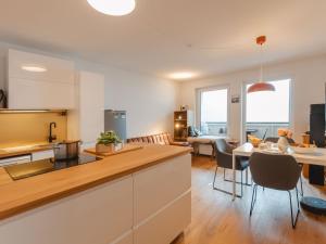 a kitchen and living room with a table and chairs at Apartment Unser Glück in den Bergen by Interhome in Bad Gastein