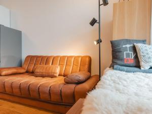 a brown leather couch sitting in a room at Apartment Unser Glück in den Bergen by Interhome in Bad Gastein