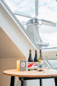 Bij Boon في Peize: زجاجتان من النبيذ تقعان على طاولة أمام النافذة