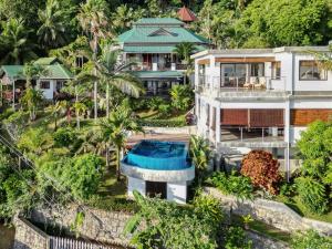 an aerial view of a house with a swimming pool at Chalets Bougainville in Takamaka