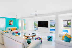 a living room with white furniture and a tv at Private Villa in Golf del Sur in San Miguel de Abona