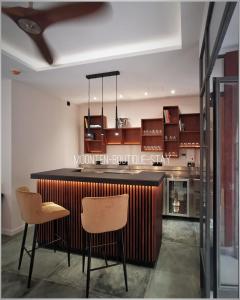 a kitchen with a bar and two chairs at MOONTEN Boutique Stay in Sóller