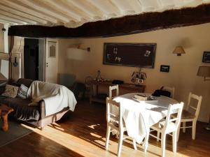 a living room with a table and a couch at Gite Du Passant Rennais avec balcon sur cour in Rennes