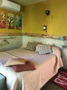 a bedroom with a bed with two pillows on it at El viento en los sauces in Sauce de Portezuelo