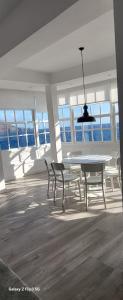 a dining room with a table and chairs and windows at The Sea Corner in Santa Cruz de la Palma