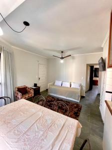 een slaapkamer met een bed en een tafel bij Apto 2 quadras da praia completo in Guarujá