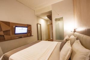 A television and/or entertainment centre at Hotel FortunaGrande Malioboro Yogyakarta