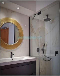 a bathroom with a sink and a shower with a mirror at MOONTEN Boutique Stay in Sóller +38 photos