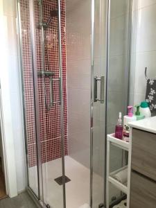 a shower with a glass door in a bathroom at “Apartamento moderno y acogedor in Madrid