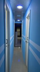 a hallway with blue walls and a hallway with doors at Deluxe Loft Rooms near Burjuman Metro Station , Bur Dubai in Dubai